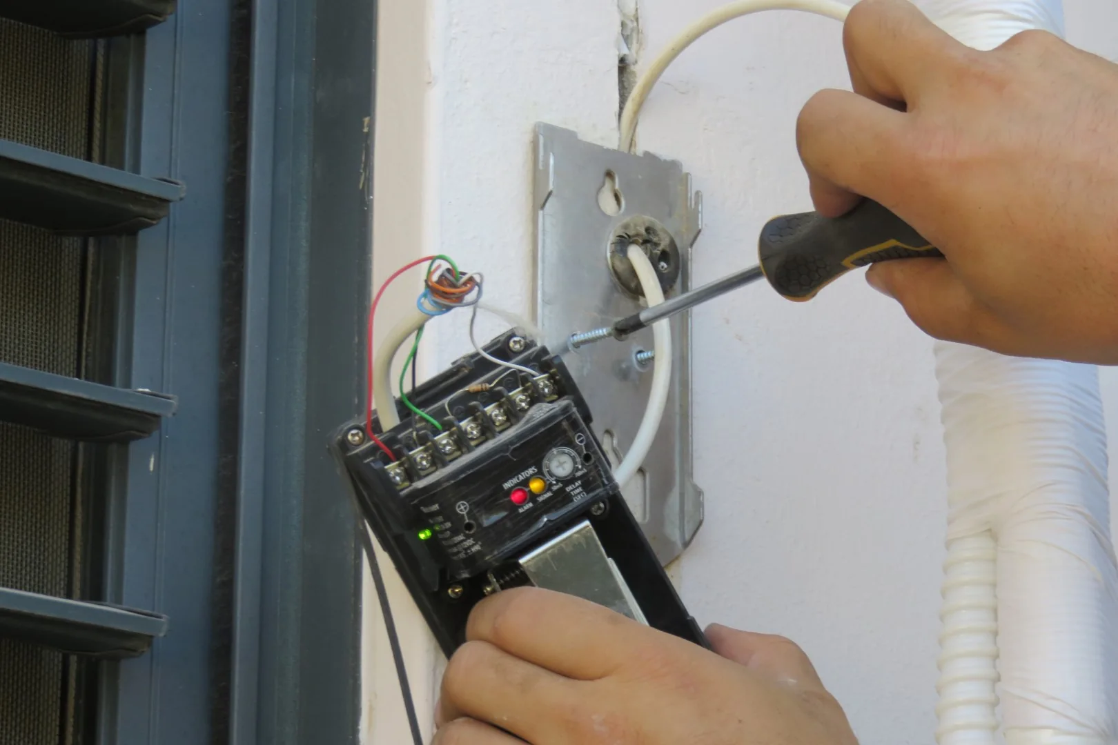 Technician working on door access hardware