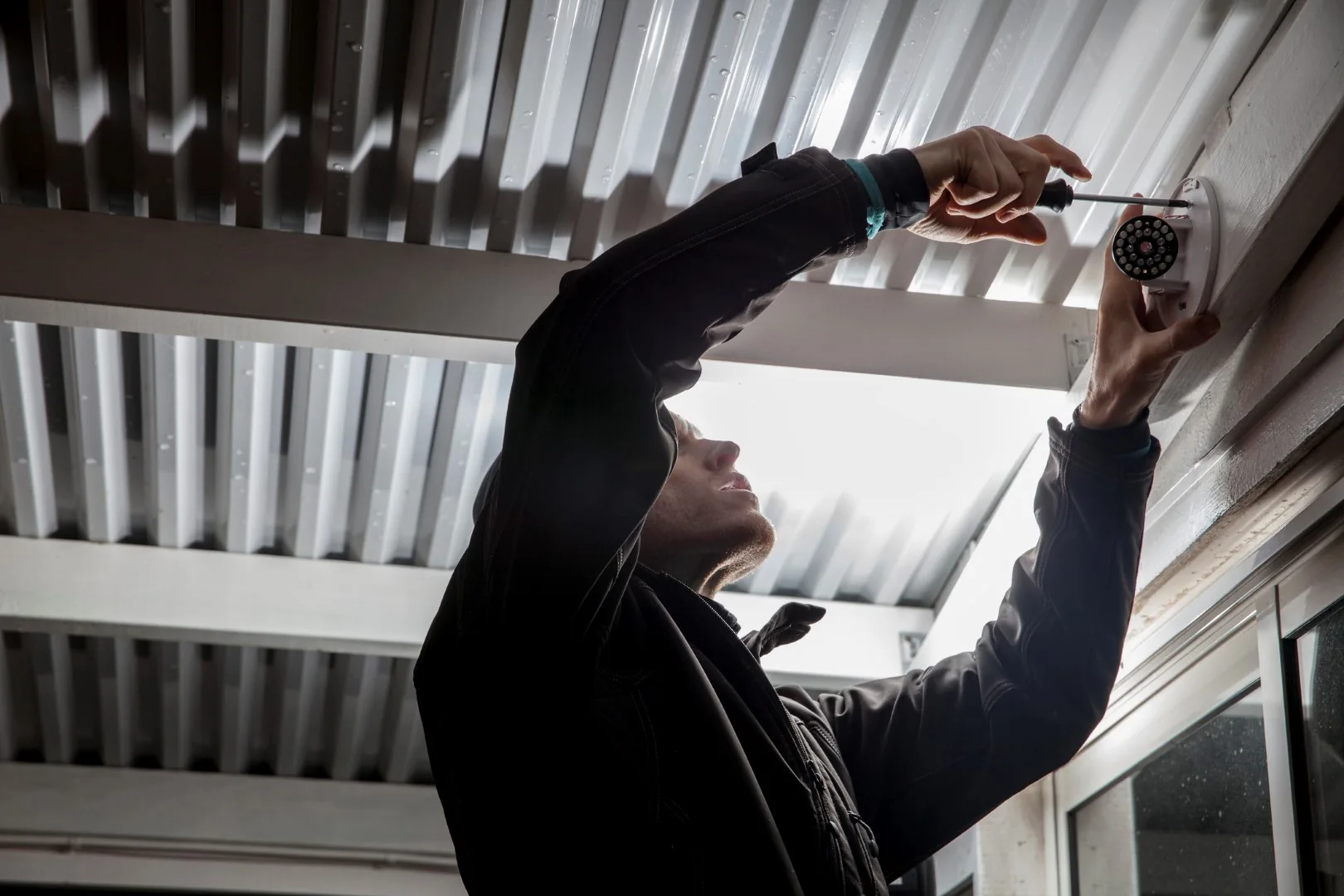 Engineer working on an overhead CCTV installation